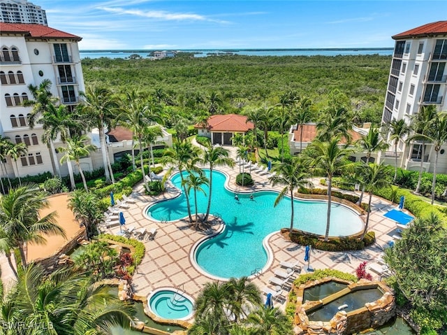 community pool featuring a patio and a water view