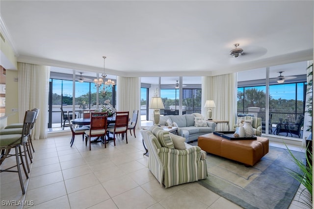 living room with light tile patterned floors, ceiling fan with notable chandelier, and expansive windows