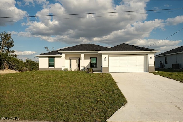 view of front of property with a garage, a front yard, and central air condition unit