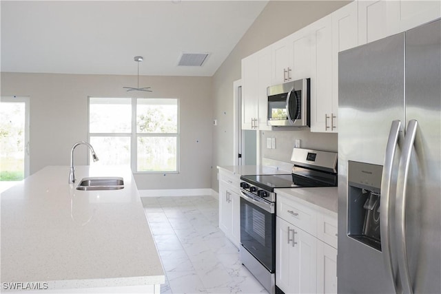 kitchen with appliances with stainless steel finishes, a kitchen island with sink, sink, and a wealth of natural light