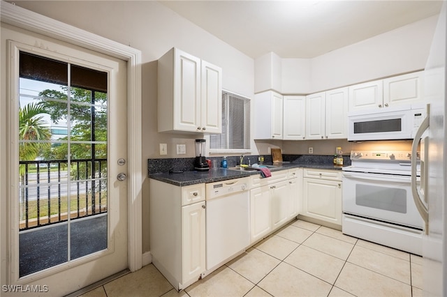 kitchen featuring white cabinetry, white appliances, sink, and light tile patterned floors