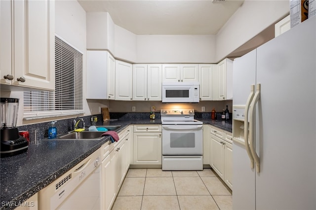 kitchen with light tile patterned floors, white appliances, white cabinetry, and sink