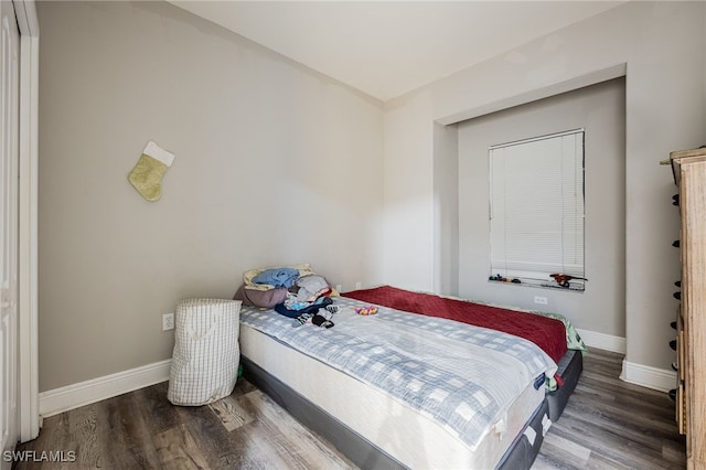 bedroom with hardwood / wood-style flooring