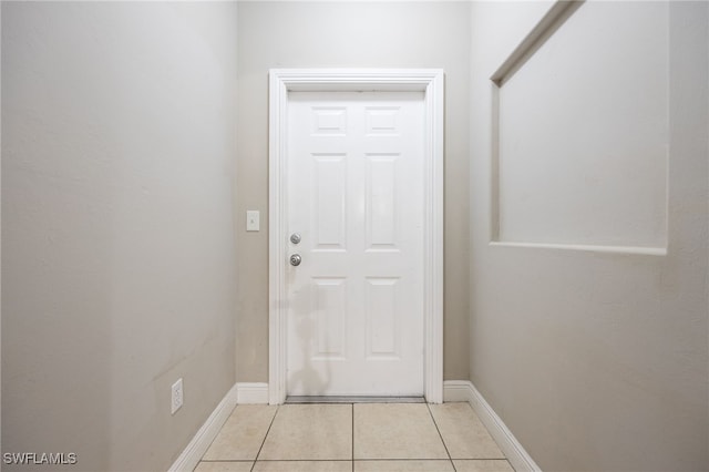 doorway with light tile patterned flooring