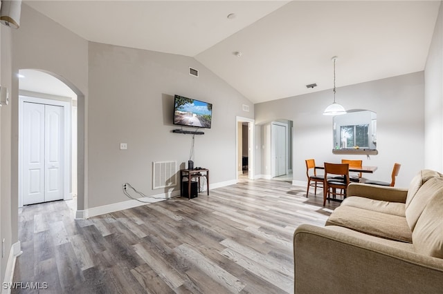 living room featuring hardwood / wood-style flooring and vaulted ceiling