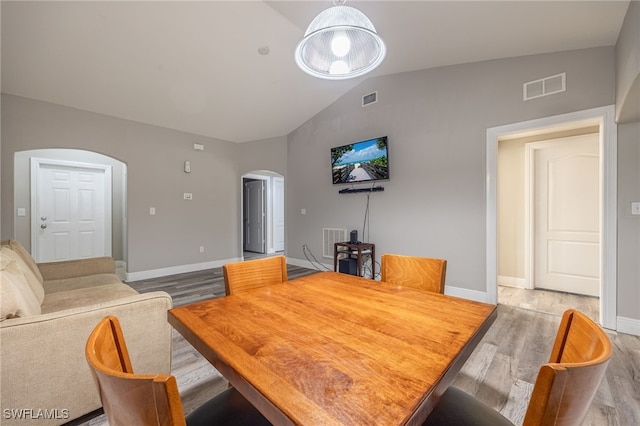 dining space featuring light hardwood / wood-style flooring and lofted ceiling