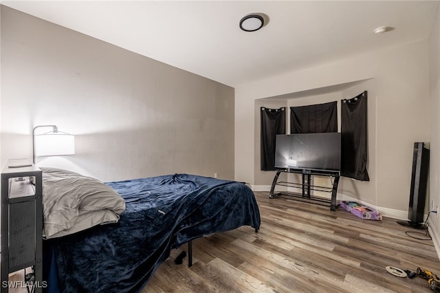 bedroom with hardwood / wood-style flooring