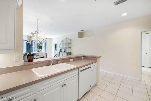 kitchen featuring visible vents, an inviting chandelier, white dishwasher, a sink, and white cabinetry