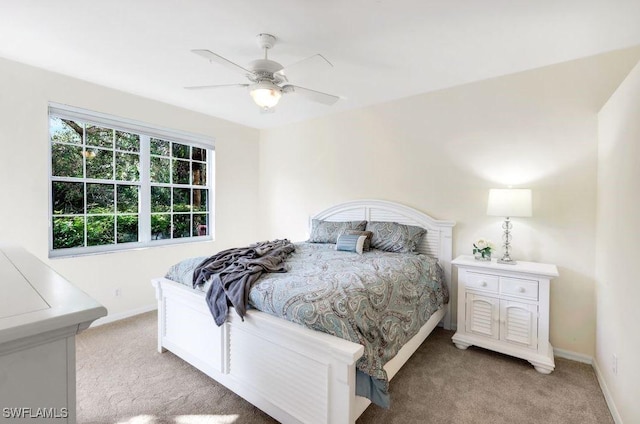 bedroom with baseboards, light carpet, and a ceiling fan