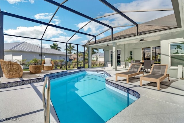 view of swimming pool featuring glass enclosure, ceiling fan, and a patio area