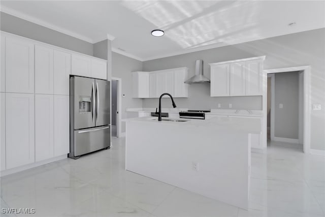 kitchen featuring white cabinetry, sink, wall chimney exhaust hood, stainless steel refrigerator with ice dispenser, and a kitchen island with sink