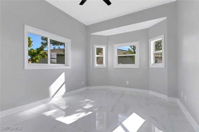 unfurnished room featuring ceiling fan and plenty of natural light