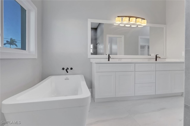 bathroom with a tub and vanity