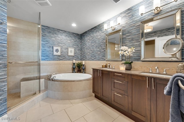 bathroom with vanity, separate shower and tub, tile patterned flooring, and tile walls