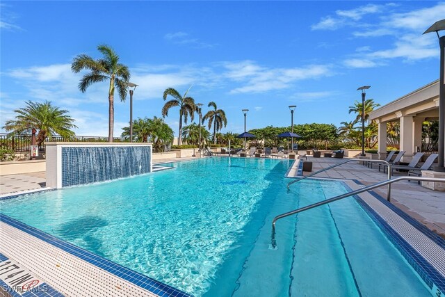 view of swimming pool with a patio area and pool water feature