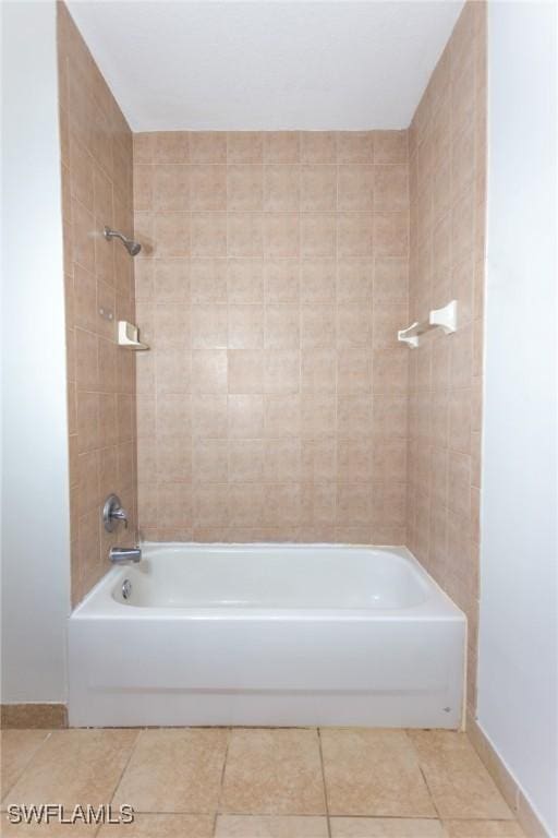 bathroom featuring tile patterned floors and tiled shower / bath