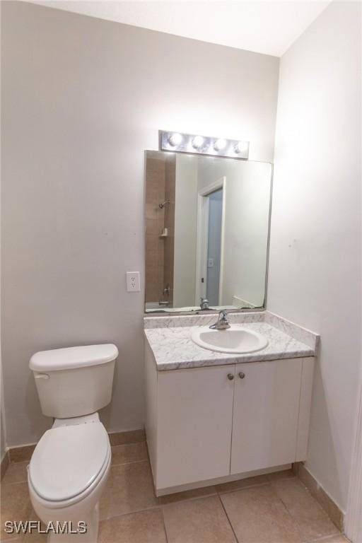 bathroom with tile patterned floors, vanity, and toilet