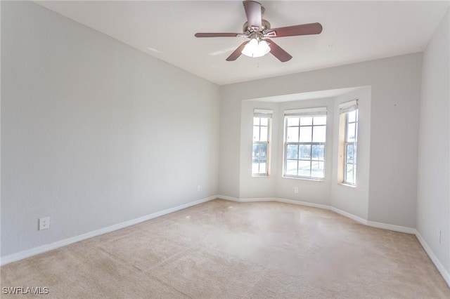 unfurnished room featuring light colored carpet and ceiling fan