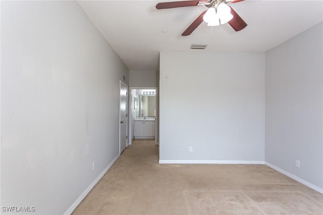 carpeted empty room featuring ceiling fan