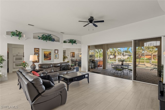 living room with ceiling fan and light wood-type flooring