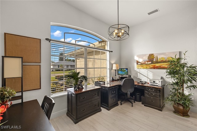 office space featuring plenty of natural light, light hardwood / wood-style floors, and a notable chandelier