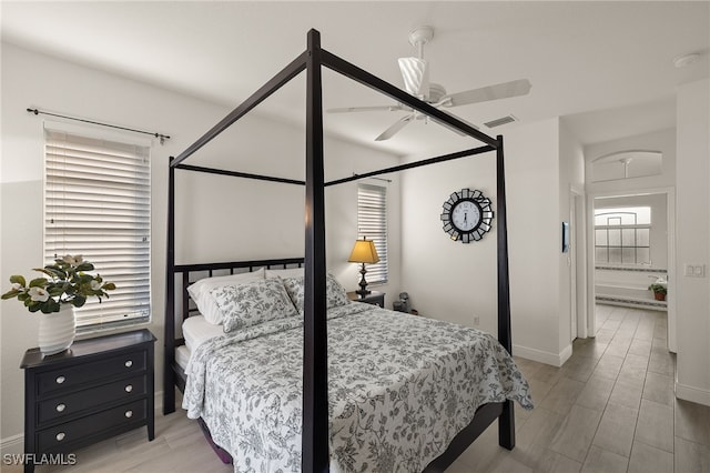 bedroom featuring ensuite bath and ceiling fan