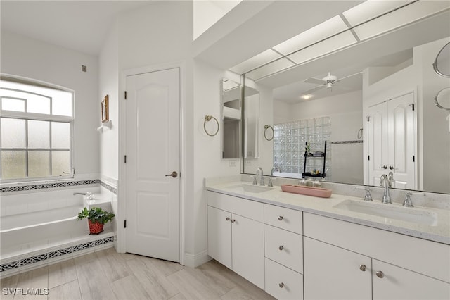 bathroom featuring a bath, vanity, and ceiling fan