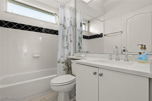 full bathroom with vanity, shower / bath combo, and toilet