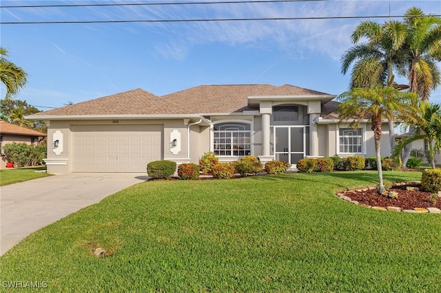 view of front of property with a garage and a front lawn