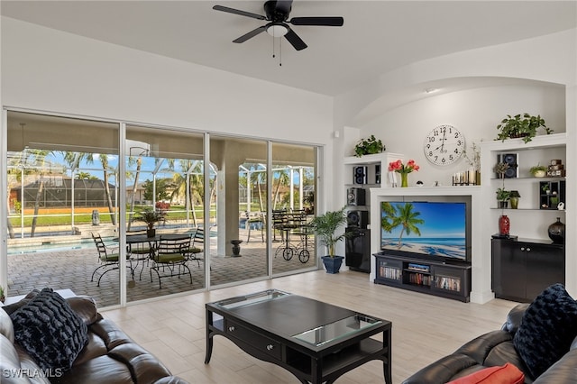 living room with light hardwood / wood-style floors and ceiling fan