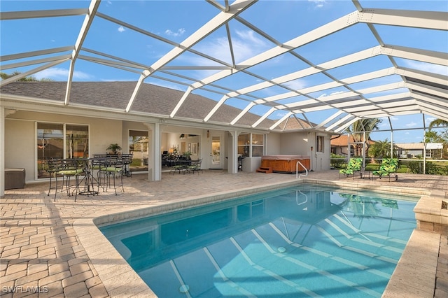 view of pool featuring a patio, a hot tub, and a lanai