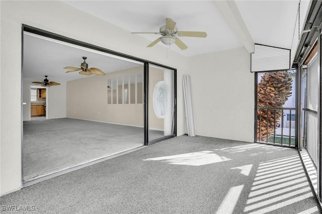 unfurnished sunroom featuring ceiling fan and beamed ceiling