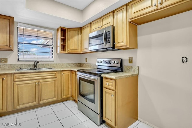 kitchen featuring sink, light tile patterned flooring, and appliances with stainless steel finishes