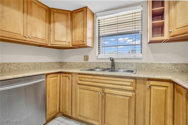 kitchen featuring sink, stainless steel dishwasher, and light tile patterned flooring