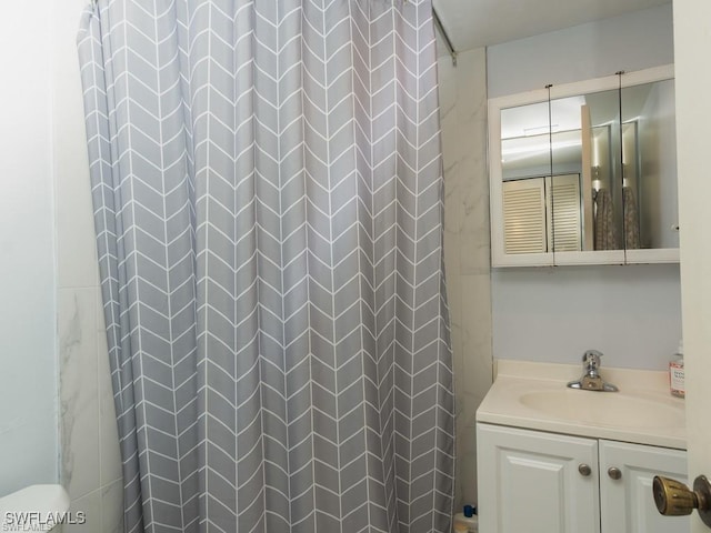 bathroom with curtained shower and vanity