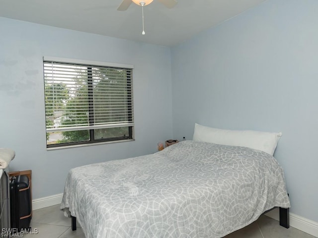 bedroom with ceiling fan and light tile patterned flooring