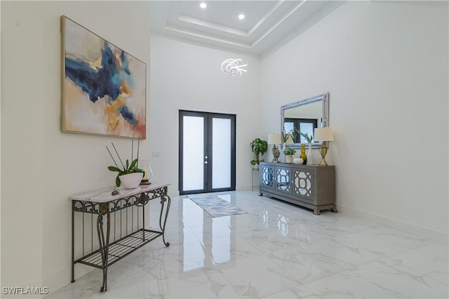 foyer featuring french doors and a high ceiling