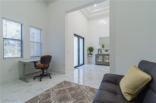 office area featuring french doors and a towering ceiling