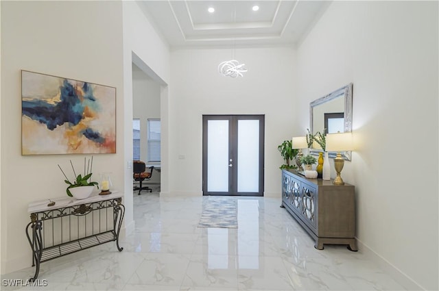 entrance foyer with french doors and a high ceiling