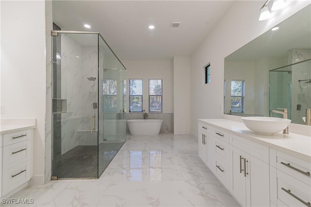 bathroom featuring plus walk in shower and vanity