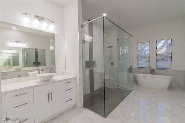 bathroom featuring vanity and separate shower and tub