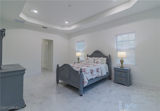 bedroom featuring a raised ceiling