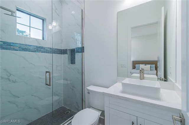 bathroom featuring vanity, toilet, and a shower with door