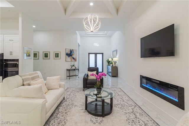 living room featuring a towering ceiling and an inviting chandelier