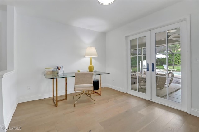 office with baseboards, wood finished floors, and french doors