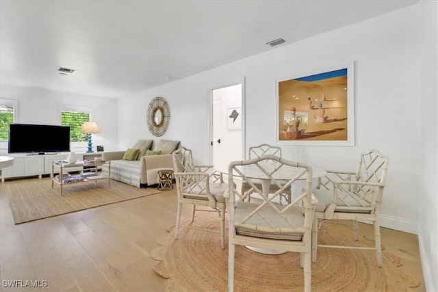 dining space with visible vents and light wood-style floors