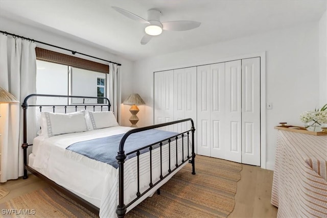 bedroom featuring a closet, wood finished floors, and ceiling fan
