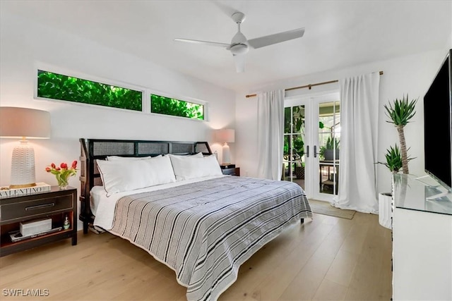 bedroom with access to exterior, french doors, multiple windows, and light wood finished floors
