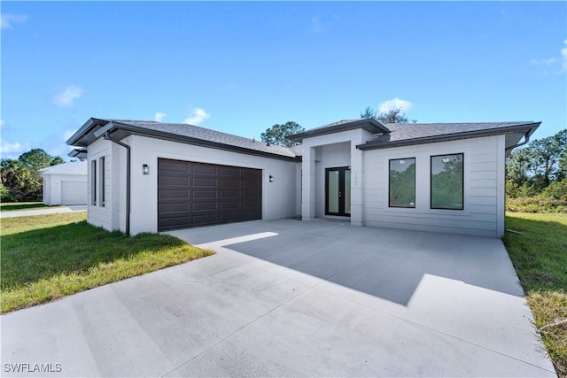 view of front of house with a front lawn and a garage