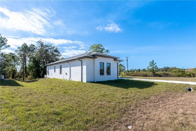 view of side of property with a lawn